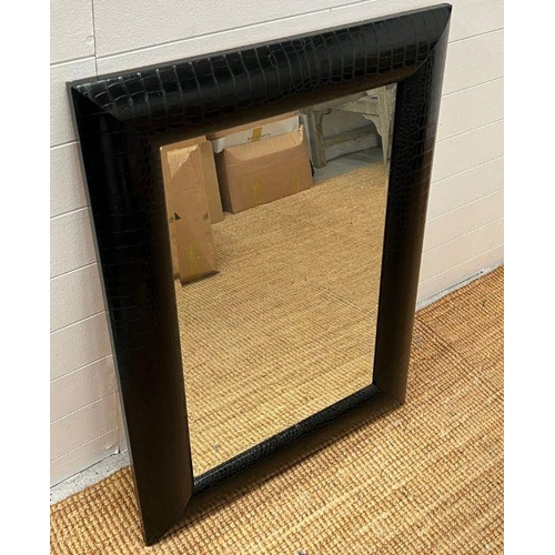 255 - A cushion style frame mirror (72cm x 98cm)