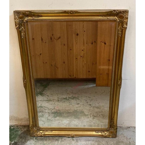 256 - A pair of wooden gold painted hall mirrors