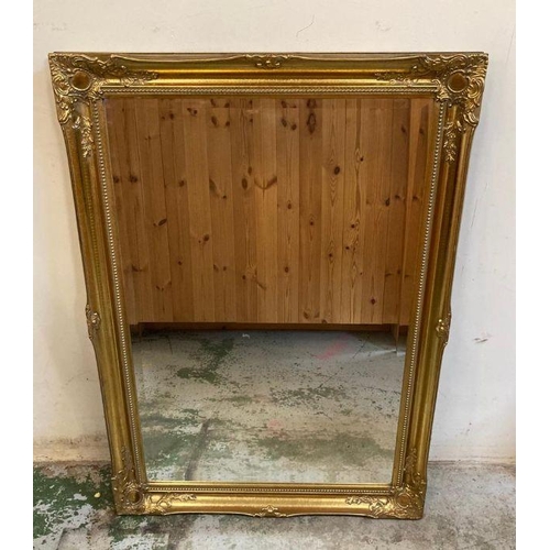 256 - A pair of wooden gold painted hall mirrors