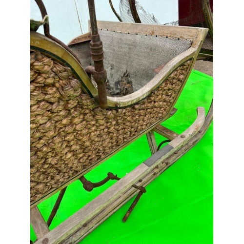 263 - A wooden and woven original sledge carriage (H125cm W220cm D140cm)