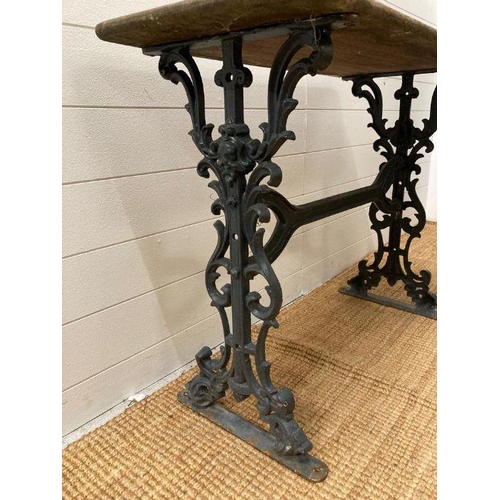 277 - A reclaimed cast iron garden table with wooden top