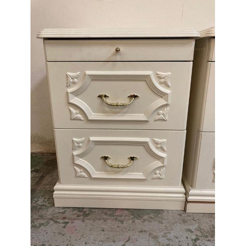 28 - A pair of white bedside tables with brass effect handles