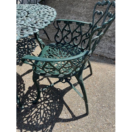 288 - A metal garden table with four chairs with scrolling design (H68cm Dia100cm)