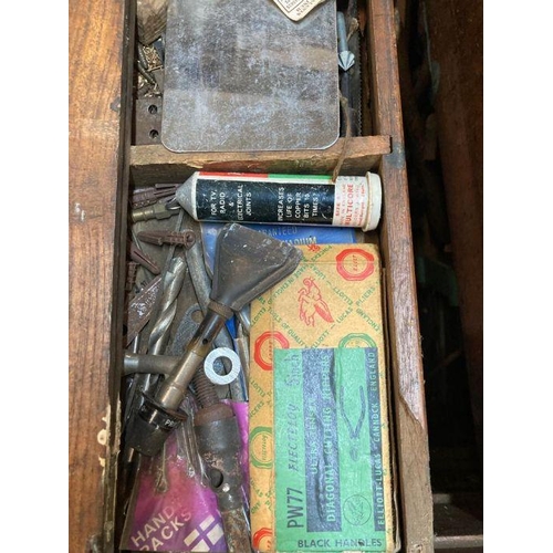 304 - A large vintage wooden steal banded tool box with cast iron handles containing and extensive collect... 