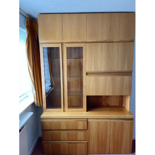 37 - A large wall unit consisting of three drawers and two cupboards to base, a drink cabinet and two doo... 