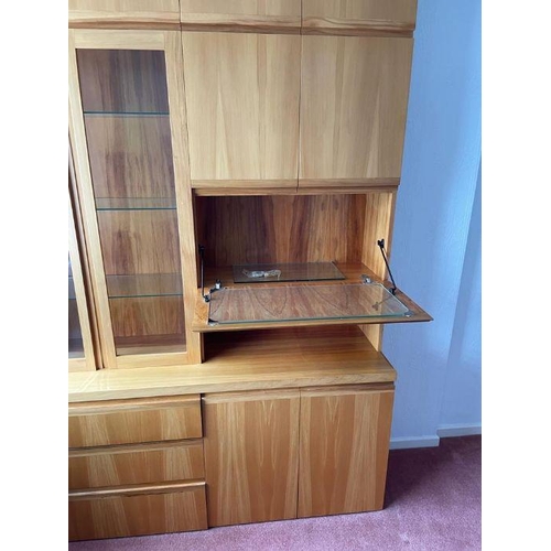 37 - A large wall unit consisting of three drawers and two cupboards to base, a drink cabinet and two doo... 