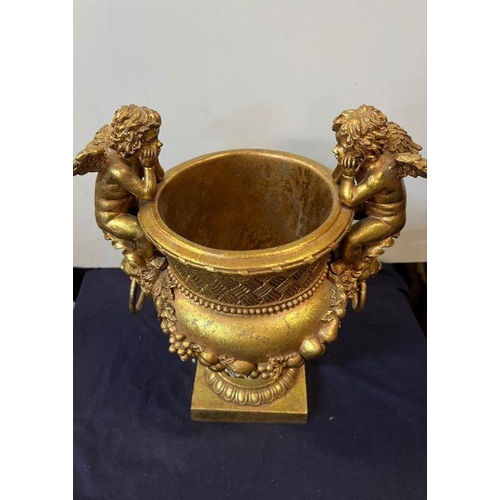 379 - A gilt vase with cupids to side