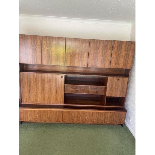 38 - A large Mid Century wall unit with three drawers under, three cupboards over and a middle section wi... 