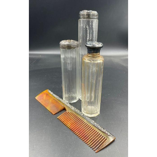 423 - Three silver topped glass bottles and an AF silver mounted comb