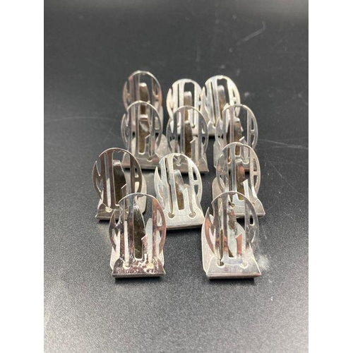 426 - A set of eleven antique sterling silver name place holders, with the initials MLA by Lebolt.