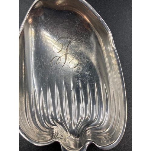 439 - A Sterling silver serving spoon with shell handle by WHITING MANUFACTURING COMPANY