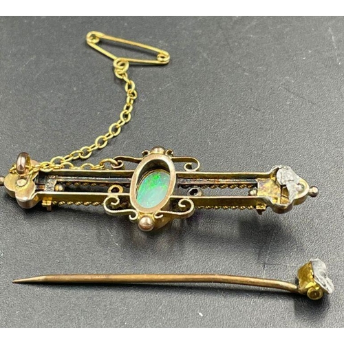 484 - An Opal and ruby brooch in a gold setting AF