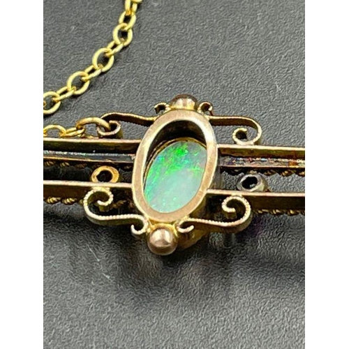 484 - An Opal and ruby brooch in a gold setting AF