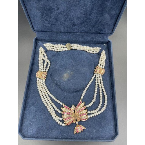 500 - A pearl necklace with a 15ct gold pendant