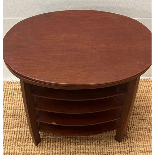 52 - An oval side table with central shelves 60cm x 63cm