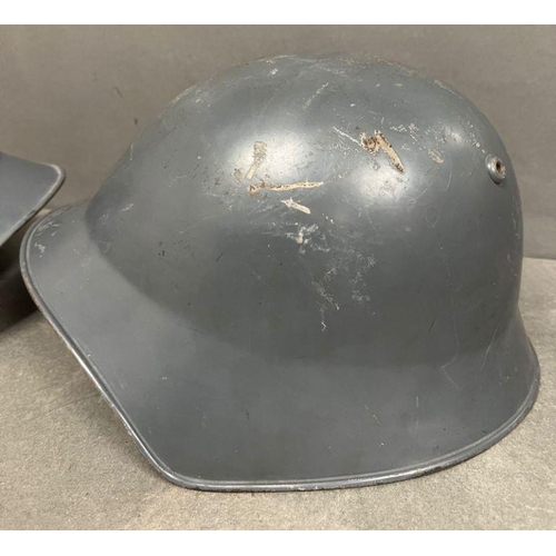 575 - Two metal military helmets with leather interior