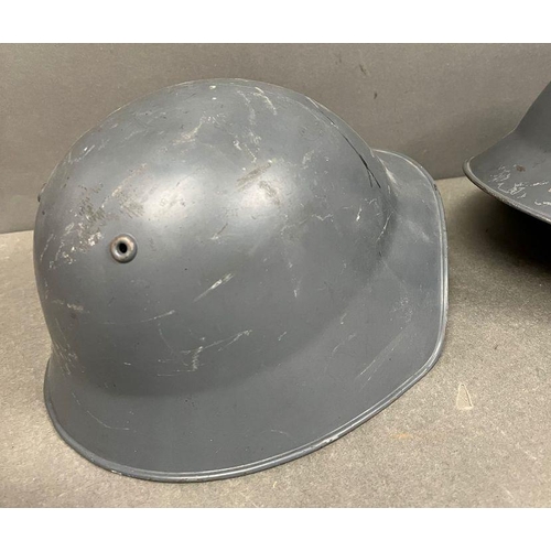 575 - Two metal military helmets with leather interior