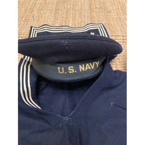 581 - A US Naval uniform to include hats, tunic and trousers