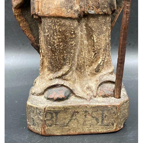 592 - A wooden carved statue of Saint Blaise the bishop of Sebask, possibly 14th Century