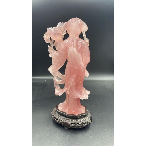 597 - A Rose quartz Chinese figure on stand (Approximate total height without stand is 25cm)