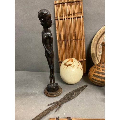 603 - A selection of African items to include spear heads, musical instruments and a painted ostrich egg