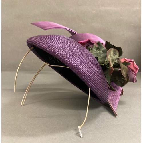 608 - A purple fascinator with purple sculpted twist intertwined with faux rose detail