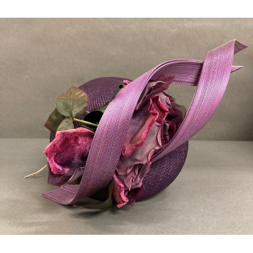 608 - A purple fascinator with purple sculpted twist intertwined with faux rose detail