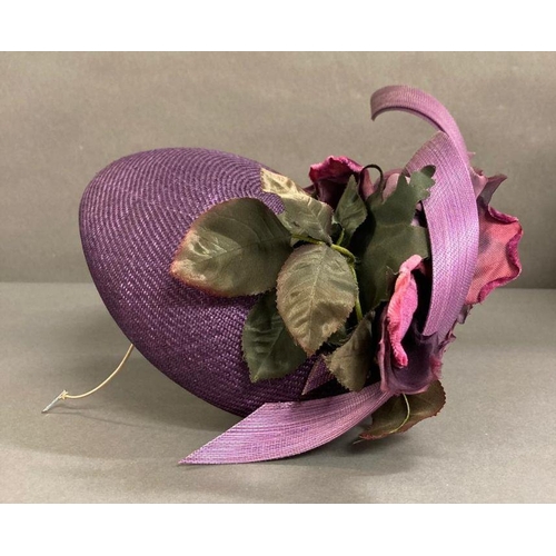 608 - A purple fascinator with purple sculpted twist intertwined with faux rose detail