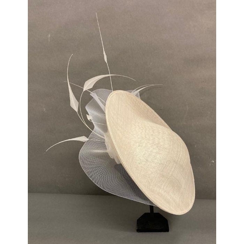 609 - A champagne saucer fascinator with feather and satin rose trim