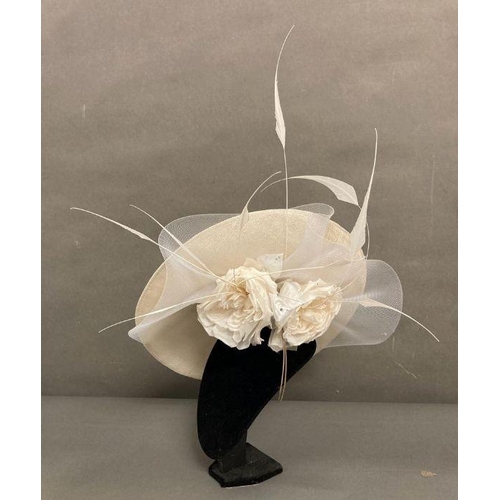 609 - A champagne saucer fascinator with feather and satin rose trim