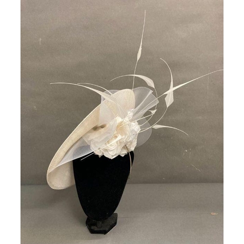 609 - A champagne saucer fascinator with feather and satin rose trim