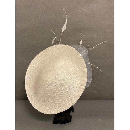 609 - A champagne saucer fascinator with feather and satin rose trim