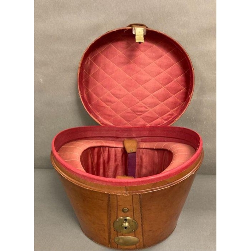 610 - A Burton silk top hat in an antique leather and brass case, size 59 (Case strap in need of repair)