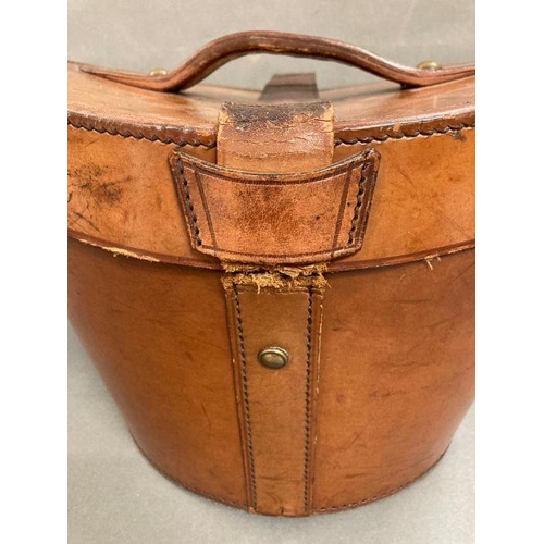 610 - A Burton silk top hat in an antique leather and brass case, size 59 (Case strap in need of repair)