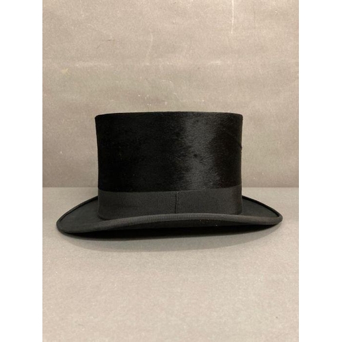 610 - A Burton silk top hat in an antique leather and brass case, size 59 (Case strap in need of repair)