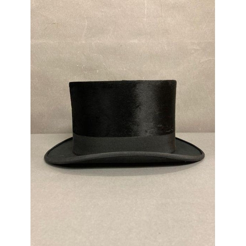 610 - A Burton silk top hat in an antique leather and brass case, size 59 (Case strap in need of repair)