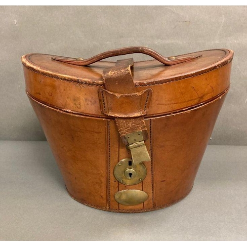 610 - A Burton silk top hat in an antique leather and brass case, size 59 (Case strap in need of repair)