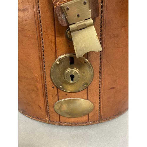 610 - A Burton silk top hat in an antique leather and brass case, size 59 (Case strap in need of repair)