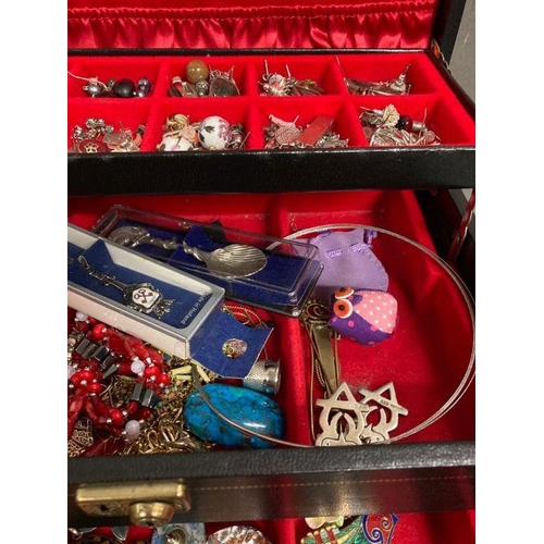 614 - A leather jewellery box containing a large collection of costume jewellery.