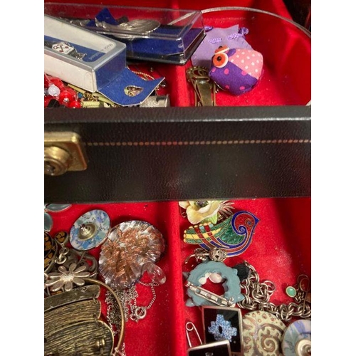 614 - A leather jewellery box containing a large collection of costume jewellery.