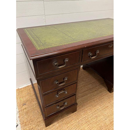 62 - A mahogany pedestal desk with green leather top (H77cm W120cm D61cm)