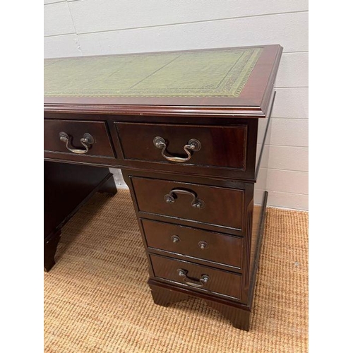 62 - A mahogany pedestal desk with green leather top (H77cm W120cm D61cm)