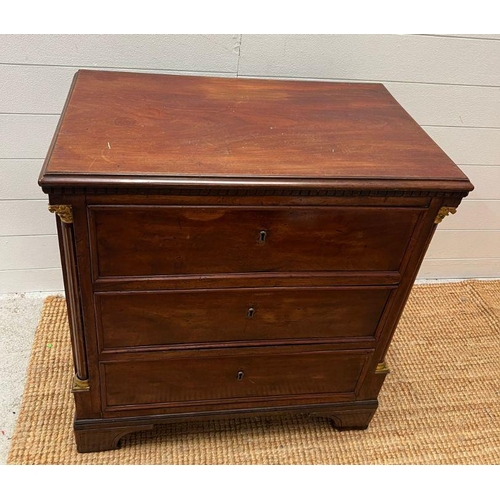 65 - An early 19th Century empire mahogany chest of three drawers, having fluted columns and gilt mefu ca... 