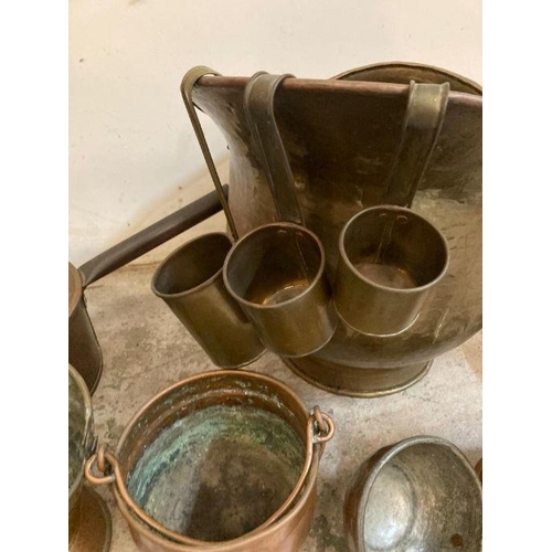 653 - A selection of copper and brass items to include a coal scuttle, teapot and a chestnut roaster