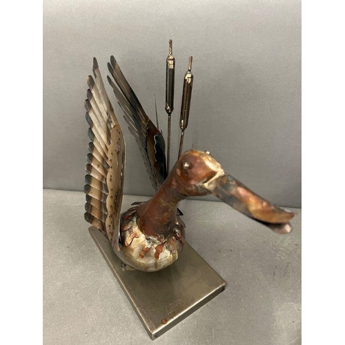 665 - A metal sculpture of a duck taking flight