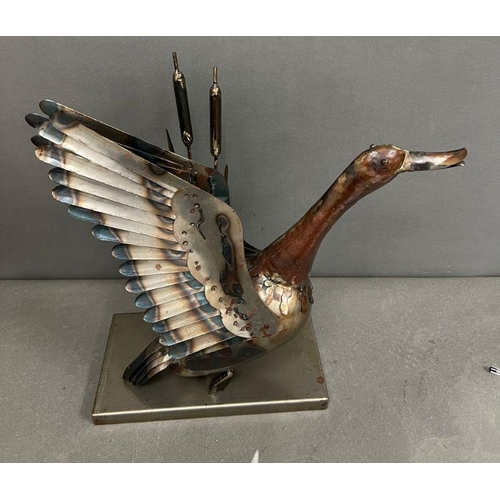 665 - A metal sculpture of a duck taking flight