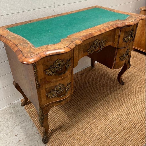 67 - An early 19th Century Italian walnut shaped front desk on cabriole legs with substation gilt metal m... 