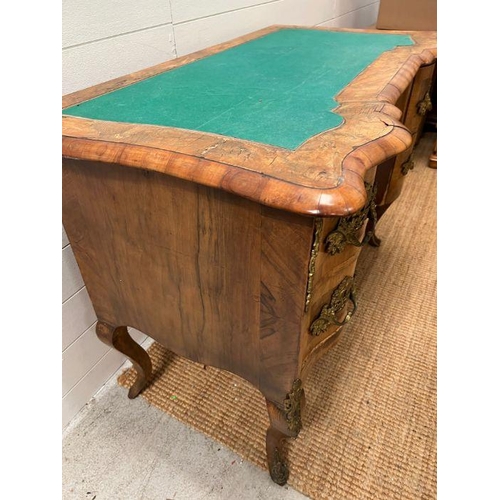 67 - An early 19th Century Italian walnut shaped front desk on cabriole legs with substation gilt metal m... 