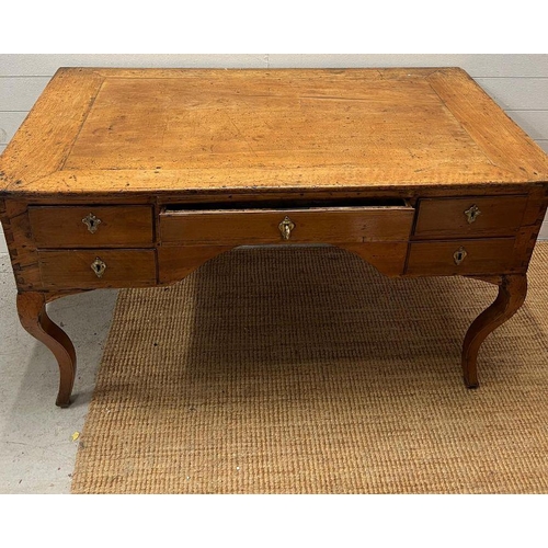 68 - An early 19th Century fruit wood provincial desk having an arrangement of five drawers on slight cab... 