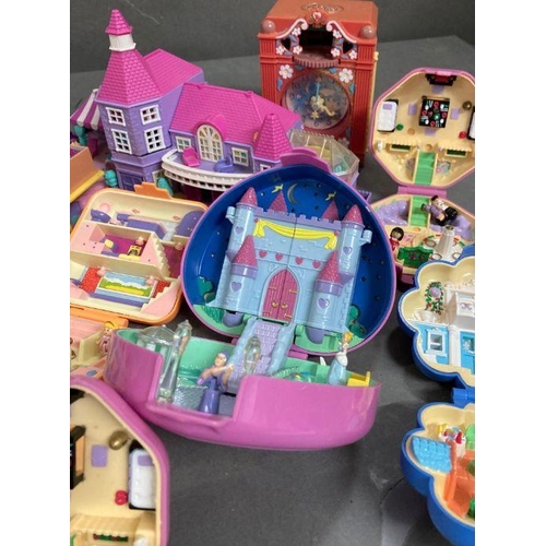 708 - An extensive selection of Polly Pocket toys  to include clocks and make up case